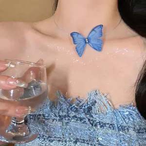 Detail of a blue gauzy butterfly choker with sparkling rhinestones on an invisible string.