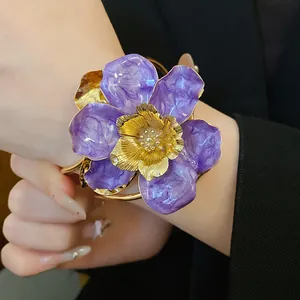 Detailed close-up of a large purple enamel flower cuff bracelet with gold-tone accents