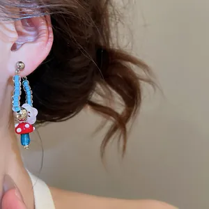 Detail view of cute retro mushroom and flower glass beaded hoop earrings for women