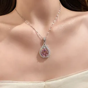 Detailed view of an elegant teardrop pendant necklace featuring a brilliant pink center zircon.