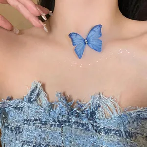 Detailed macro view of a blue snow gauze butterfly choker with rhinestone center