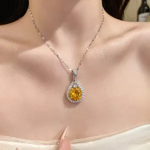 Close-up of an elegant teardrop necklace with a brilliant yellow zircon pendant.