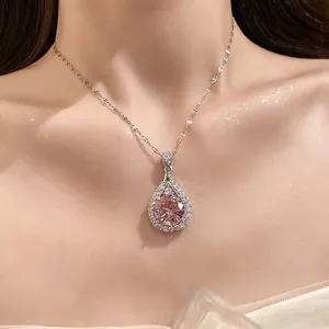 Detailed shot of an elegant silver teardrop necklace with a radiant pink zircon gemstone.