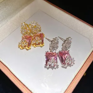 Vintage palace style earrings with large square pink zircons in gold and silver finish.