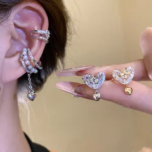 Detailed view of elegant Korean heart zircon ear cuffs with pearl and cross accents