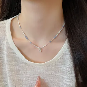 Detailed macro shot of an elegant cube crystal and pearl beaded collarbone necklace