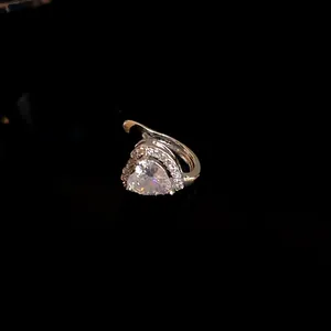 Close-up of heart-shaped zircon ear clip with silver-tone setting for non-pierced ears