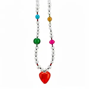 Colorful handmade necklace featuring freshwater pearls and a vibrant red heart pendant