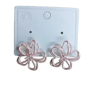 Elegant pink hollow flower stud earrings featuring a delicate floral cutout design for women