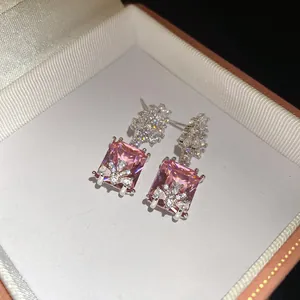 Detailed view of vintage pink rectangular zircon drop earrings inside a premium jewelry box
