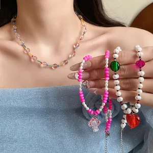 Close-up of handmade freshwater pearl necklace and bracelets with colorful charms