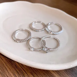 Detailansicht eines fünfteiligen offenen Ringsets mit Perlen und Strasssteinen