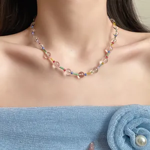 Detailed macro shot of a colorful clear beaded necklace worn on a woman's neck area