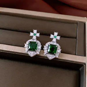Elegant vintage square green zircon earrings with palace-style accents in jewelry box.