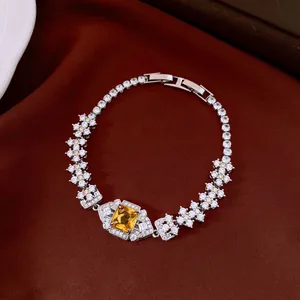 Close-up of luxury vintage bracelet with square yellow gemstone and clear pavé stones