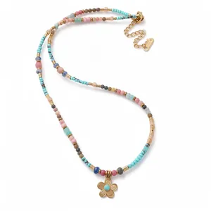 Vibrant Bohemian beaded necklace with a gold flower pendant in dopamine style