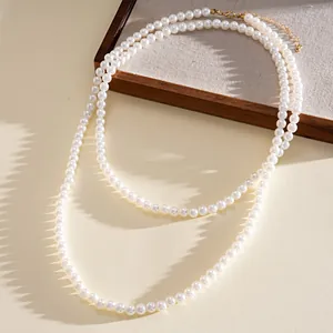 Elegant double-layer white pearl necklace with a detailed golden lobster clasp