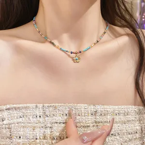Detailed view of a Bohemian colorful beaded necklace featuring a gold flower pendant