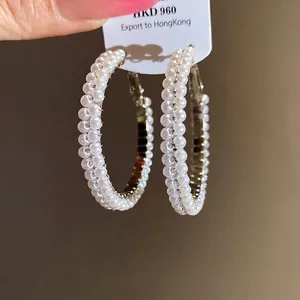 Elegant silver needle hoop earrings embellished with double-row lustrous white pearls