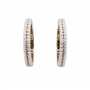 Elegant silver needle beaded hoop earrings featuring a textured vintage-inspired design.