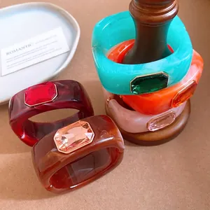 Chic square resin bangles with inlaid faceted crystals shown in various vibrant colors.