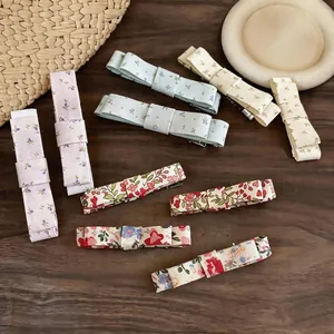 Elegant fabric floral bow hair clips with minimalist duckbill design in various patterns