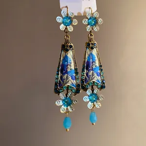 Vintage drop earrings with blue resin floral patterns and sparkling crystal accents