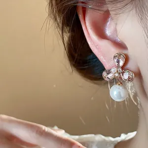 Elegant 18k gold plated flower pearl drop earrings featuring shimmering pink crystals