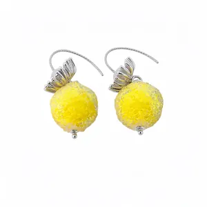 Elegant yellow textured glass sphere earrings featuring silver flower top ear hooks