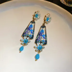 Close-up of vintage blue resin flower earrings with sparkling rhinestones and bead drops