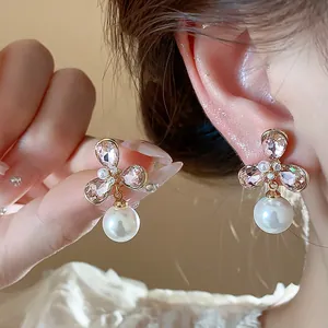 Close-up detail of vintage French style flower pearl earrings with pink crystals