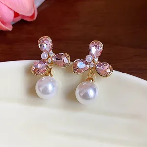 Close-up detail of vintage French style pink crystal flower earrings with white pearl