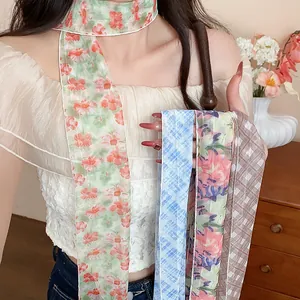 Detail of floral and plaid skinny silk scarves worn as sweet Korean style necklaces