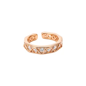 Rose gold geometric ring featuring triangular zircon inlays on a clean white backdrop