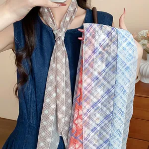 Detail shot of multi-patterned plaid skinny scarves styled as a sweet necktie necklace