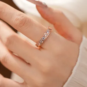 Close-up of rose gold geometric ring featuring triangle cutouts with clear zircon stones