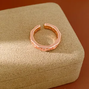 Macro view showing detailed geometric facets and zircon inlays on rose gold ring