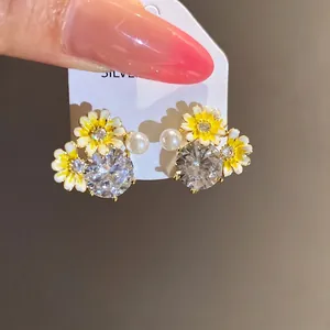 Elegant sunflower stud earrings with shimmering zircons and delicate pearls on silver needles
