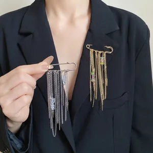 Elegant retro chain tassel safety pin brooch with colorful stones on a black blazer