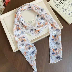 Detail of a Korean style floral silk scarf with elegant orange and purple petal patterns.
