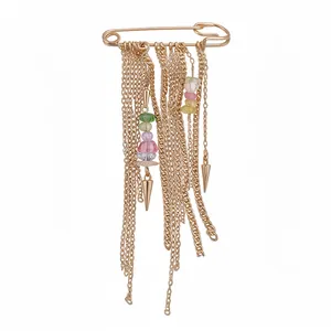 Vintage gold safety pin brooch featuring multi-colored beads and cascading metal chains