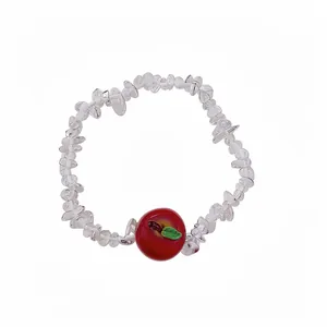 Sweet resin beaded bracelet featuring a charming red apple pendant on white background.