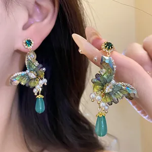 Elegant butterfly earrings with emerald crystals, pearls and green teardrop pendants