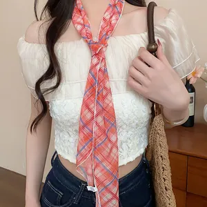 Detail shot of a sweet Korean style red plaid skinny scarf necklace on a model.