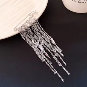 Macro view of silver safety pin brooch with elegant long chain tassels and stones