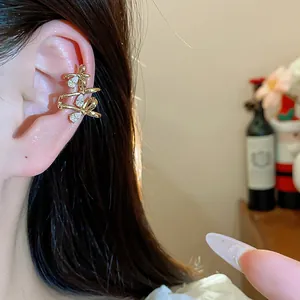 Close-up detail of 18k gold plated bowknot ear cuff featuring sparkling cubic zirconia