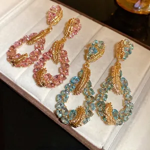 Elegant gold-plated feather water drop earrings set with pink and blue oval gemstones