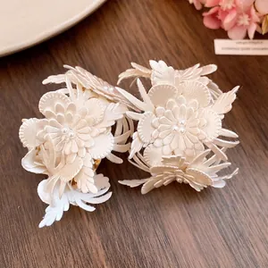 Vintage white leather flower C-shaped earrings featuring elegant pearl center details.