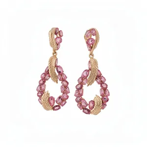 Elegant pink gemstone drop earrings with gold feather design in a waterdrop shape