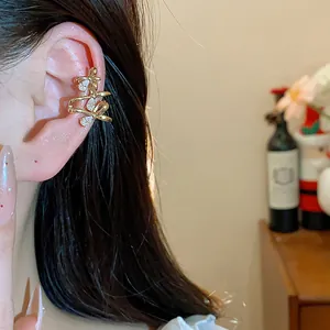 Detailed view of an elegant 18k gold plated ear cuff featuring shimmering zircon bows